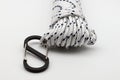 White braided polypropylene rope with black carabiner isolated on white background