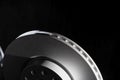 White brake discs on a black background. Efficient braking, safety. Copy space for text Royalty Free Stock Photo