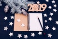 Blue background stars christmas tree branch white bump notebook letters symbols 2019 decoration top view greeting card