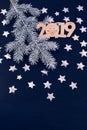 Blue background stars christmas tree branch white bump notebook letters symbols 2019 decoration top view greeting card