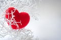 White branch with red fluffy heart over white