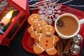 White branches three Gingerbread men side view with mug of coffee red dis Royalty Free Stock Photo