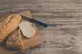 White bread cut on cutting board and wooden table. Royalty Free Stock Photo