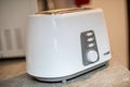 White bread toaster sitting on the kitchen counter. with blured background