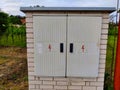 White brick box with double-door for electrical distribution grid maintenance entrance Royalty Free Stock Photo