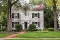 White Brick Georgian Colonial House with Flagpole Royalty Free Stock Photo