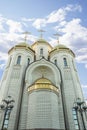 White brick orthodox church with three golden domes. Royalty Free Stock Photo