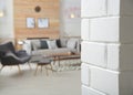 White brick wall and blurred living room interior Royalty Free Stock Photo