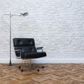 White Brick Wall Interior With Black Leather Office Armchair