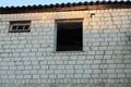 White brick wall of an old house with empty broken windows Royalty Free Stock Photo