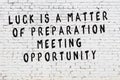 White brick wall with painted black motivational quote inscription