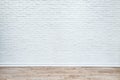 White brick wall and plank wood floor. Royalty Free Stock Photo