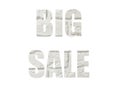 White brick wall. Shot through the cut-out silhouette of the word BIG SALE