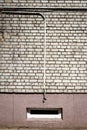 White brick wall with some cables and basement window Royalty Free Stock Photo