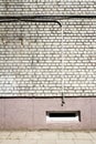 White brick wall with some cables and basement window Royalty Free Stock Photo