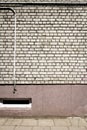 White brick wall with some cables and basement window Royalty Free Stock Photo