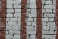 White brick wall with stripes of red paint. Old brick wall with painted red. Bricks background, pattern, texture. Grunge masonry f Royalty Free Stock Photo
