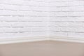 White brick wall with tiled floor, abstract background photo Royalty Free Stock Photo