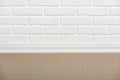 White brick wall with tiled floor closeup photo, abstract background photo Royalty Free Stock Photo