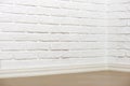 White brick wall with tiled floor and corner, abstract background photo Royalty Free Stock Photo