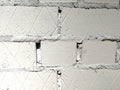 White bricks painted with diagonal lines and the number three.  Fragment of the wall.  Abstract textural background Royalty Free Stock Photo