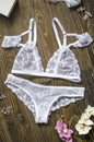 White bridal lace lingerie on the brown wooden background. Fasi