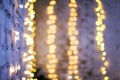 White brike wall with blurred background with bokeh lights, electric garland Royalty Free Stock Photo