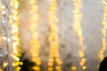 White brike wall with blurred background with bokeh lights, electric garland. Royalty Free Stock Photo