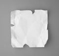 White broken and creased paper note on a gray backgroun