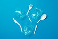 White broken single-use plastic knives, spoons, forks and plastic drink straws on a blue background. Say no to single use plastic Royalty Free Stock Photo