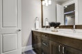 White and brown bathroom boasts a nook filled with double vanity Royalty Free Stock Photo