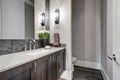 White and brown bathroom boasts a nook filled with taupe vanity Royalty Free Stock Photo