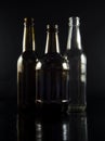 White and brown bottles on black background. Royalty Free Stock Photo