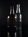 White and brown bottles on black background. Royalty Free Stock Photo