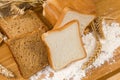 White and brown bread for toasting with ears and flour