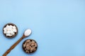 white and brown cane sugar sand and refined sugar in a wooden bowl on a blue background with copy space Royalty Free Stock Photo