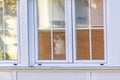 White and brown cat sitting looking at the street through the glass of a building window in Madrid, Spain. Europe. Royalty Free Stock Photo