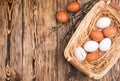 White and brown eggs in the basket on the table. Easter Royalty Free Stock Photo