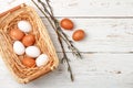 White and brown eggs in the basket on the table. Easter Royalty Free Stock Photo