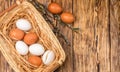 White and brown eggs in the basket on the table. Easter Royalty Free Stock Photo