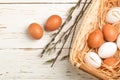 White and brown eggs in the basket on the table. Easter Royalty Free Stock Photo