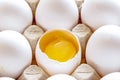 White and brown eggs in carton with broken egg Royalty Free Stock Photo