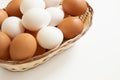 Chicken eggs in the wicker basket on white background Royalty Free Stock Photo