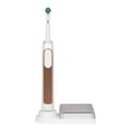 White with brown electronic toothbrush on a charge stand or tips container Royalty Free Stock Photo