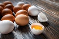 White and brown farm eggs lie on a wooden table, close-up, low light, selective focus, shallow depth of field. Organic Royalty Free Stock Photo