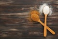 White and brown sugar in wood spoon on brown background Royalty Free Stock Photo