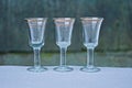 White brown three glass crystal goblets on a gray wooden table Royalty Free Stock Photo