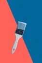 White brush with wooden handle on a blue aund coral background Royalty Free Stock Photo
