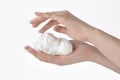 White bubbled foam in hands, hair foam, foam for man, white textured, hand full of soap isolated on white background, finger touch