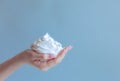 White bubbled foam in woman`s nice hand